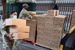 Sgt. Thalia Santos from Yonkers, N.Y., a member of the New York Army National Guard, carries boxed meals to a waiting vehicle at a food distribution site in The Bronx, N.Y., August 5, 2020. Senior Airman Sean Madden